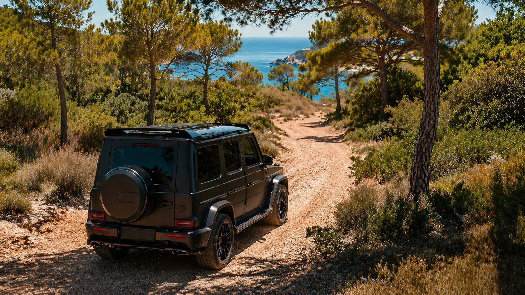 Land Rover Defender rental Ibiza — luxury 4x4 on dirt track to secluded beach